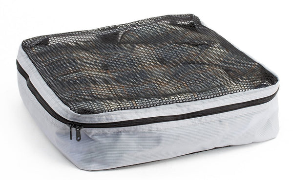 A filled and zipped closed Northwest Sky (light grey) Aether Large Aeronaut 30 Packing Cube.